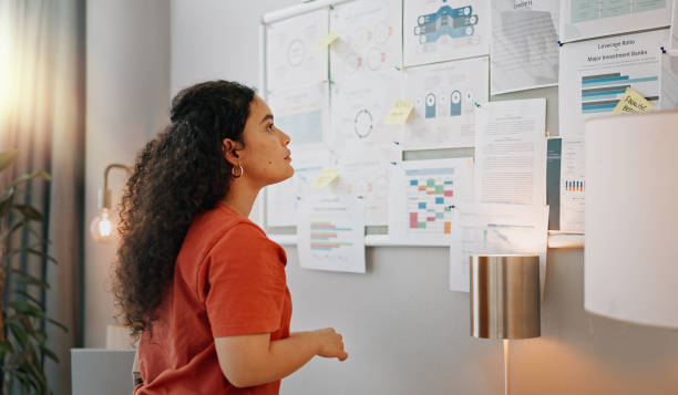 Woman looking at a bulletin board.